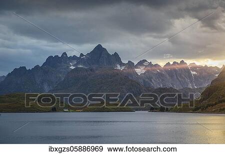 Rugged peaks of the mountain range Trolltindan in the rays of the evening sun, Hadsel, Nordland, Lofoten, Norway, Europe View Large Photo Image Stock Photo - Rugged peaks of the mountain range Trolltindan in the rays of the evening sun, Hadsel, Nordland, Lofoten, Norway, Europe. Fotosearch