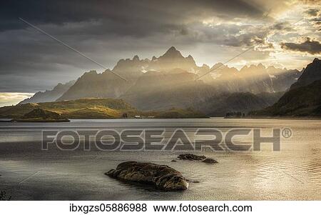 Rugged peaks of the mountain range Trolltindan in the rays of the evening sun, Hadsel, Nordland, Lofoten, Norway, Europe View Large Photo Image Stock Photo - Rugged peaks of the mountain range Trolltindan in the rays of the evening sun, Hadsel, Nordland, Lofoten, Norway, Europe. Fotosearch