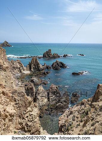 Stock Image - Rugged rocky coast, rocks in the sea, Arrecife de las Sirenas, Cabo de Gata-Nijar National Park, Almeria, Spain, Europe. Fotosearch