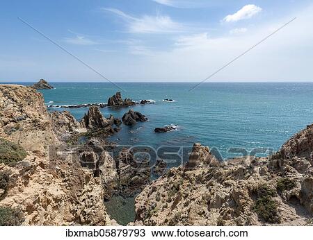 Stock Image - Rugged rocky coast, rocks in the sea, Arrecife de las Sirenas, Cabo de Gata-Nijar National Park, Almeria, Spain, Europe. Fotosearch