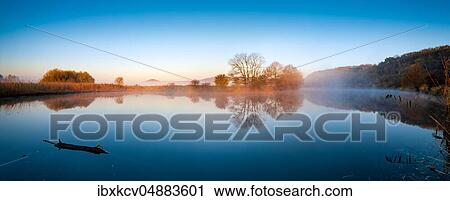Stock Image - Saalealtarm with morning fog, water reflection, Lower Saale Valley nature park Park, Saxony-Anhalt, Germany, Europe. Fotosearch