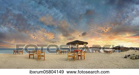 Sandy beach beach with bar at the coral reef Abu-Dabbab at sunset, Hilton Nubian Resort, Al Qusair, Marsa Alam, Egypt, Africa View Large Photo Image Stock Photo - Sandy beach beach with bar at the coral reef Abu-Dabbab at sunset, Hilton Nubian Resort, Al Qusair, Marsa Alam, Egypt, Africa. Fotosearch