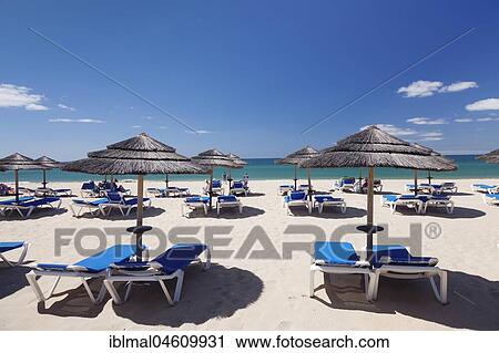 Sandy beach beach with umbrellas and sunbeds, Praia de tres Irmaos, Alvor, Algarve, Portugal, Europe View Large Photo Image Stock Image - Sandy beach beach with umbrellas and sunbeds, Praia de tres Irmaos, Alvor, Algarve, Portugal, Europe. Fotosearch