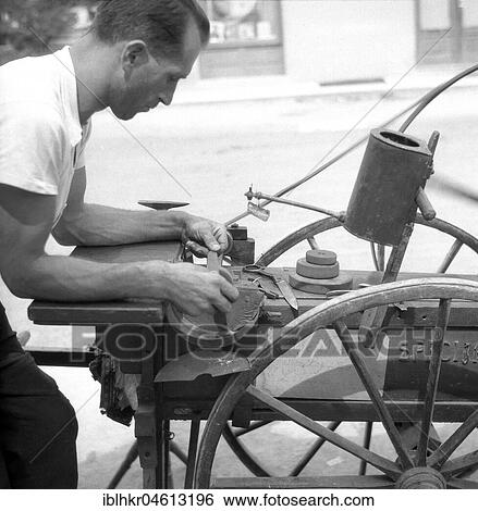 Stock Photograph - Scissors grinder at work, approx. 1945 to 1955, Freiburg, Germany, Europe. Fotosearch