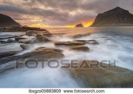 Sea surf in warm evening light with coastal landscape on Lofoten, Haukland Strand, Vestvågøy, Lofoten, Nordland, Norway, Europe View Large Photo Image Stock Photo - Sea surf in warm evening light with coastal landscape on Lofoten, Haukland Strand, Vestvågøy, Lofoten, Nordland, Norway, Europe. Fotosearch
