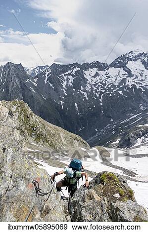 Stock Photo - Secured path along the hiking trail, hiker on the descent from the Mörchnerscharte to the Floitengrund, Small and Large Mörchner, Berliner Höhenweg, Zillertal Alps, Zillertal, Tyrol, Austria, Europe. Fotosearch