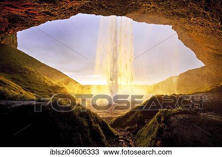 Stock Image - Seljalandsfoss waterfall in the back light, Seljalandsa river, South Island, Island. Fotosearch