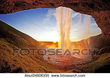 Stock Photography - Seljalandsfoss waterfall in the back light, Seljalandsa river, South Island, Island. Fotosearch