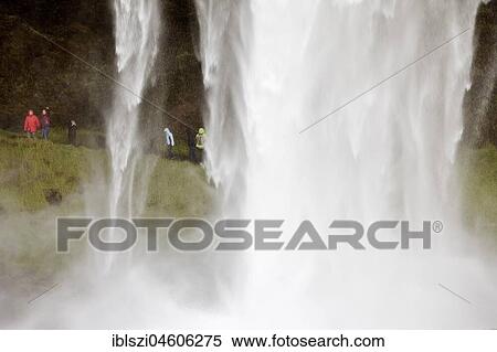 Seljalandsfoss waterfall with people behind it, Seljalandsa river, South Iceland View Large Photo Image Stock Photography - Seljalandsfoss waterfall with people behind it, Seljalandsa river, South Iceland. Fotosearch