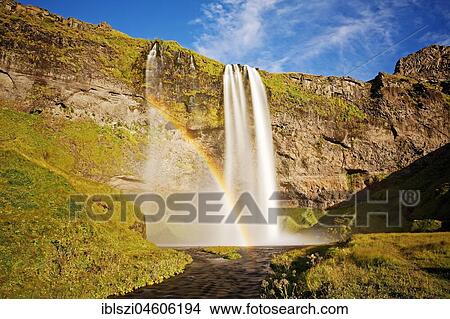 Seljalandsfoss waterfall with rainbow, Seljalandsa river, South Island, Island View Large Photo Image Picture - Seljalandsfoss waterfall with rainbow, Seljalandsa river, South Island, Island. Fotosearch