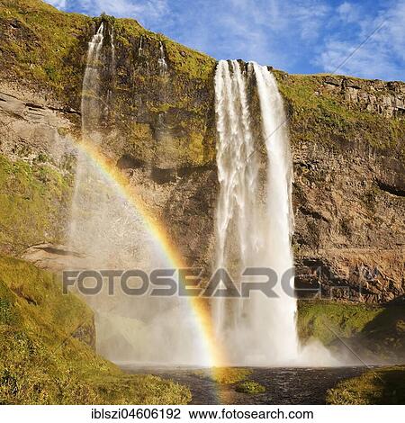 Stock Image - Seljalandsfoss waterfall with rainbow, Seljalandsa river, South Island, Island. Fotosearch