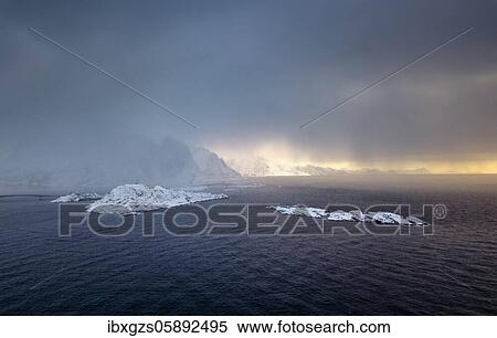 Snowfall over the sea and mountains, dense clouds, Reine, Nordland, Lofoten, Norway, Europe View Large Photo Image Stock Photography - Snowfall over the sea and mountains, dense clouds, Reine, Nordland, Lofoten, Norway, Europe. Fotosearch