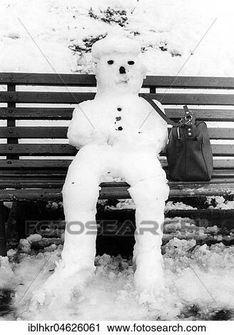 Stock Image - Snowman nit bag sits on bench ca. 1970s, exact place unknown, Czech Republic, Europe. Fotosearch