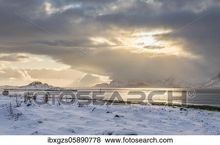Snowy landscape at sea and fjord, cloud atmosphere, warm sunlight, Nordland, Lofoten, Norway, Europe View Large Photo Image Stock Photo - Snowy landscape at sea and fjord, cloud atmosphere, warm sunlight, Nordland, Lofoten, Norway, Europe. Fotosearch
