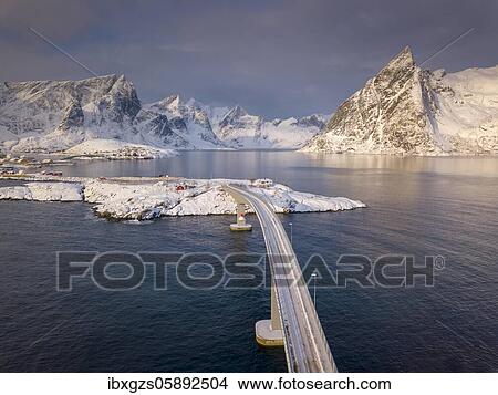 Picture - Snowy landscape by the fjord with Hamnoy bridge, drone picture, Hamnøy, Nordland, Lofoten, Norway, Europe. Fotosearch