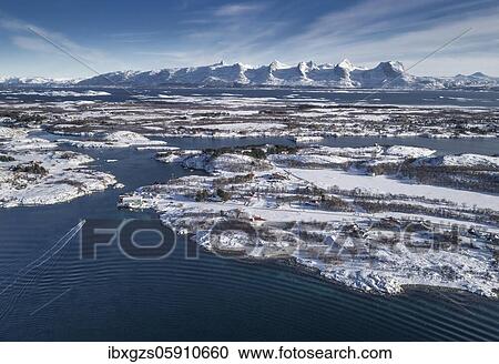 Stock Image - Snowy mountain range Seven Sisters, De syv søstre, Sju søstre, front winter archipelago islands in the sea, Herøy, Nordland, Norway, Europe. Fotosearch