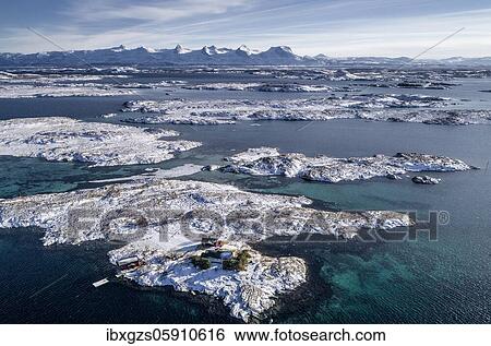 Stock Photograph - Snowy mountain range Seven Sisters, De syv søstre, Sju søstre, front winter archipelago islands in the sea, Herøy, Nordland, Norway, Europe. Fotosearch