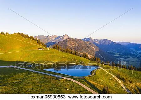 Stock Image - Storage lake Walleralm at Sudelfeld in the morning light, near Bayrischzell, Mangfall mountains, drone image, Upper Bavaria, Bavaria, Germany, Europe. Fotosearch