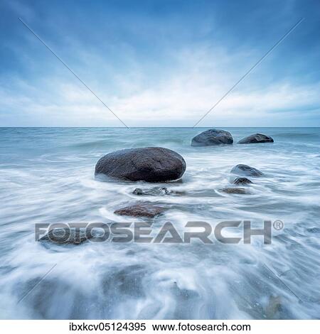 Stock Photography - Stormy winter day at the Baltic Sea, boulders in the surf, Baltic resort Rerik, Mecklenburg-Western Pomerania, Germany, Europe. Fotosearch