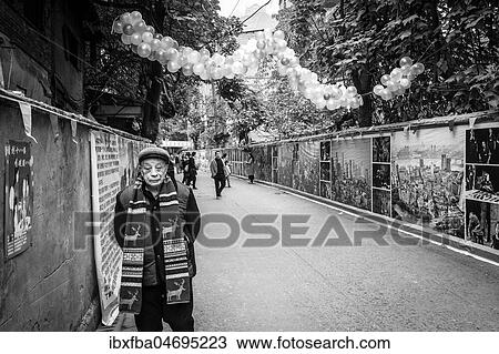 Stock Image - Street scene in an old town quarter of Chongqing. Photos of the new dwellings into which the people are to be resettled. These districts are gradually being demolished to make room for new residential areas with high-rise buildings, Chongqing, China, Asia. Fotosearch