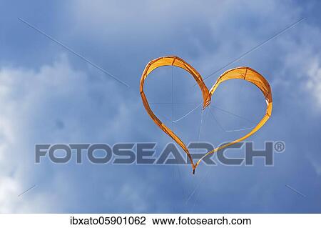 Sunlit heart-shaped dragon, orange heart in front of cloudy sky, North Rhine-Westphalia, Germany, Europe View Large Photo Image Stock Image - Sunlit heart-shaped dragon, orange heart in front of cloudy sky, North Rhine-Westphalia, Germany, Europe. Fotosearch