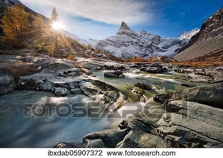 Stock Image - Sunrise at Ferpècle, behind it snowy Mont Miné, Val d'Hérens, Canton Valais, Switzerland, Europe. Fotosearch