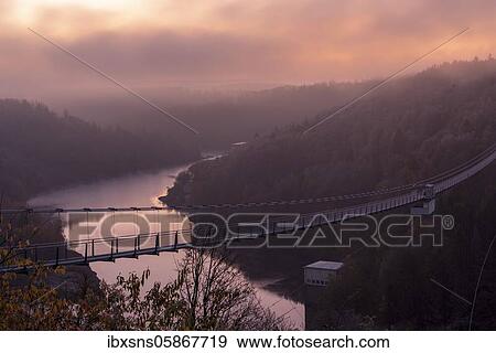 Stock Photo - Sunrise at the Rappbode dam, hanging rope bridge, Harz Mountains, Saxony-Anhalt, Germany, Europe. Fotosearch