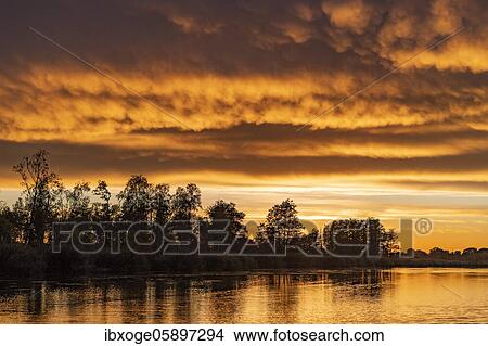 Sunset at the Peene river, nature park park river landscape Peene valley, Mecklenburg-Vorpommern, Germany, Europe View Large Photo Image Picture - Sunset at the Peene river, nature park park river landscape Peene valley, Mecklenburg-Vorpommern, Germany, Europe. Fotosearch
