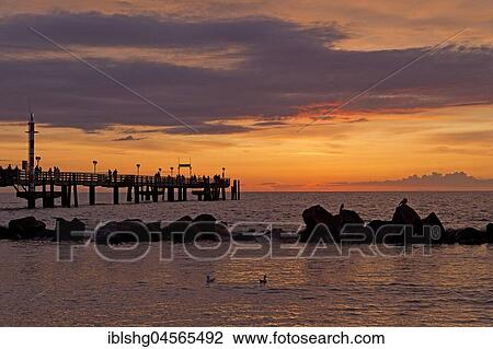 Sunset at the Seebrücke, Baltic resort Wustrow, Darß, Mecklenburg-Western Pomerania, Germany, Europe View Large Photo Image Stock Image - Sunset at the Seebrücke, Baltic resort Wustrow, Darß, Mecklenburg-Western Pomerania, Germany, Europe. Fotosearch