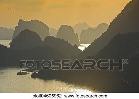 Sunset, overgrown limestone cliffs in Halong Bay, Dragon Bay, Gulf of Tonkin, Vietnam, Asia View Large Photo Image Stock Image - Sunset, overgrown limestone cliffs in Halong Bay, Dragon Bay, Gulf of Tonkin, Vietnam, Asia. Fotosearch