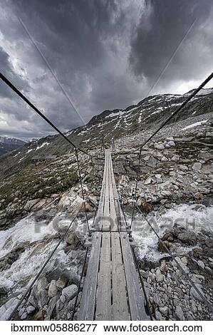 Suspension bridge over torrent at the Olpererhütte, Zillertal Alps, Glacier Schlegeiskees, Zillertal, Tyrol, Austria, Europe View Large Photo Image Stock Photo - Suspension bridge over torrent at the Olpererhütte, Zillertal Alps, Glacier Schlegeiskees, Zillertal, Tyrol, Austria, Europe. Fotosearch