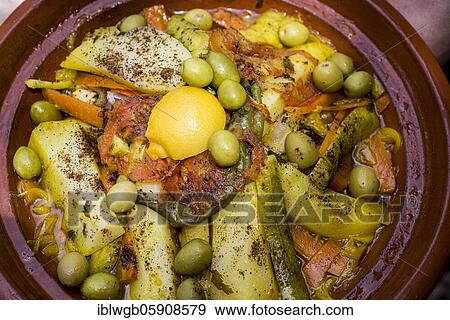 Tajine, typical Moroccan food in clay pot, chicken with lemon and olives, vegetables and potatoes, Morocco, Africa View Large Photo Image Stock Photo - Tajine, typical Moroccan food in clay pot, chicken with lemon and olives, vegetables and potatoes, Morocco, Africa. Fotosearch