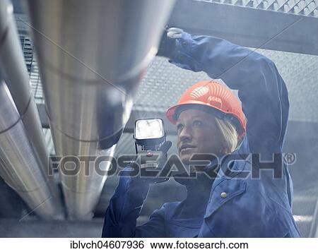 Technician, fitter with orange helmet and lamp inspected pipelines, Wattens, Tyrol, Austria, Europe View Large Photo Image Stock Photograph - Technician, fitter with orange helmet and lamp inspected pipelines, Wattens, Tyrol, Austria, Europe. Fotosearch
