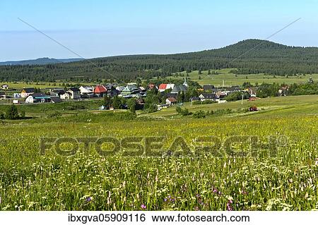 The village Boží Dar, Gottesgab, on the ridge of the Ore Mountains, in the background the mountain Božídarský Špicák, Gottesgaber Spitzberg, UNESCO World Heritage Site Ore Mountain Mining Region, Krušnohorí, Boží Dar, Bohemia, Czech Republic, Europe View Large Photo Image Stock Photograph - The village Boží Dar, Gottesgab, on the ridge of the Ore Mountains, in the background the mountain Božídarský Špicák, Gottesgaber Spitzberg, UNESCO World Heritage Site Ore Mountain Mining Region, Krušnohorí, Boží Dar, Bohemia, Czech Republic, Europe. Fotosearch