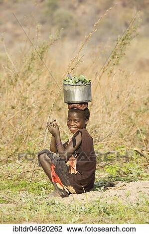 Tonga girl with vegetables, Lake Kariba, Zambia, Africa View Large Photo Image Stock Image - Tonga girl with vegetables, Lake Kariba, Zambia, Africa. Fotosearch