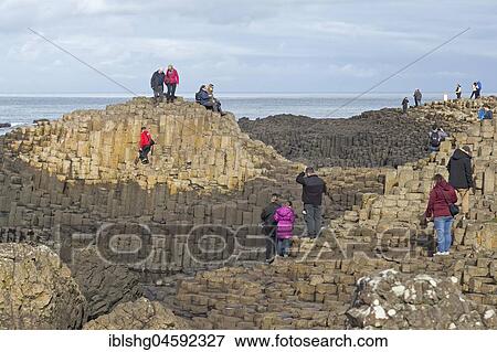 Tourists at the Basalt Columns, Giant's Causeway, Causeway Coast, County Antrim, Northern Ireland, United Kingdom, Europe View Large Photo Image Stock Photo - Tourists at the Basalt Columns, Giant's Causeway, Causeway Coast, County Antrim, Northern Ireland, United Kingdom, Europe. Fotosearch