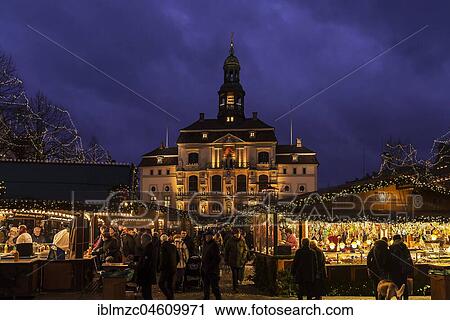 Stock Image - Town hall with Christmas market, colorful illuminated around Christmas time, Lüneburg, Lower Saxony, Germany, Europe. Fotosearch