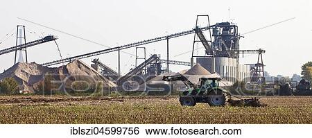 Tractor in front of gravel plant, Wesel, Niederrhein, Ruhr Area, North Rhine-Westphalia, Germany, Europe View Large Photo Image Stock Photograph - Tractor in front of gravel plant, Wesel, Niederrhein, Ruhr Area, North Rhine-Westphalia, Germany, Europe. Fotosearch