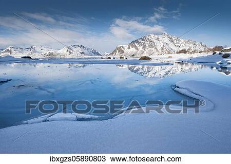 Turquoise lagoon with snow surface and ice floes, behind it snow covered mountains Sundklakktinden and Varden Anderstinden, Nordland, Lofoten, Norway, Europe View Large Photo Image Stock Image - Turquoise lagoon with snow surface and ice floes, behind it snow covered mountains Sundklakktinden and Varden Anderstinden, Nordland, Lofoten, Norway, Europe. Fotosearch