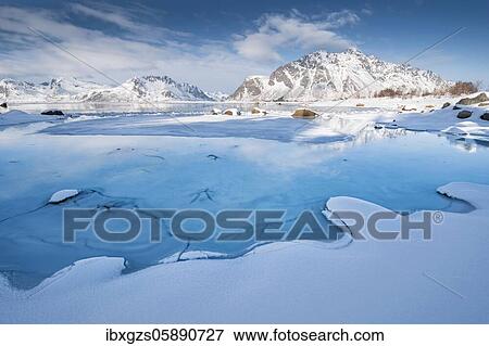 Turquoise lagoon with snow surface and ice floes, behind it snow covered mountains Sundklakktinden and Varden Anderstinden, Nordland, Lofoten, Norway, Europe View Large Photo Image Stock Photo - Turquoise lagoon with snow surface and ice floes, behind it snow covered mountains Sundklakktinden and Varden Anderstinden, Nordland, Lofoten, Norway, Europe. Fotosearch