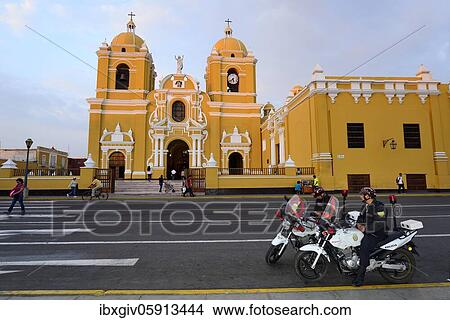 Picture - Two policemen on motorcycles in front of the cathedral in the evening light, Trujillo, La Liberdad region, Peru, South America. Fotosearch