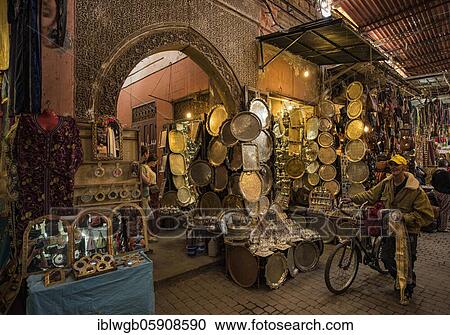 Stock Image - Typical, traditional souk, bazaar, a man pushes his bicycle, Marrakech, Morocco, Africa. Fotosearch
