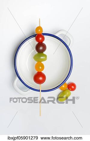 Stock Photo - Various cherry tomatoes on wooden skewers on a bowl, Germany, Europe. Fotosearch