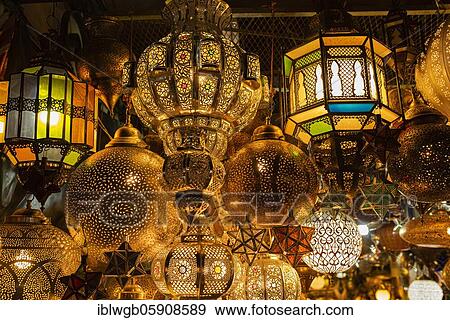 Stock Photo - Various lamps made of brass or copper and colored glass for sale hung up, souk, bazaar, Marrakech, Morocco, Africa. Fotosearch