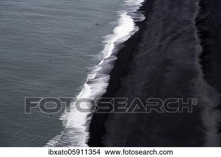 Picture - View from above on waves at the shore, black lava beach at the North Atlantic, motion blur, Cape Dyrhólaey, Vík í Mýrdal, Southern Iceland, Iceland, Europe. Fotosearch