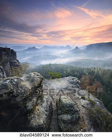 View from the Kleines Winterberg at sunrise, morning mist, Elbe Sandstone Mountains, Saxon Switzerland National Park, Saxony, Germany, Europe View Large Photo Image Picture - View from the Kleines Winterberg at sunrise, morning mist, Elbe Sandstone Mountains, Saxon Switzerland National Park, Saxony, Germany, Europe. Fotosearch