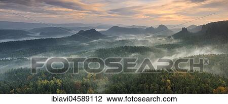 Stock Image - View from the Kleines Winterberg at sunrise, morning mist, Elbe Sandstone Mountains, Saxon Switzerland National Park, Saxony, Germany, Europe. Fotosearch