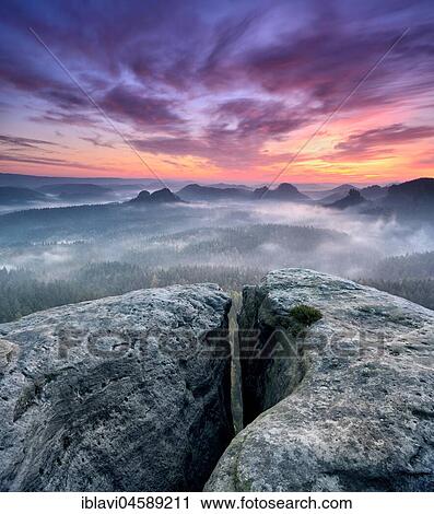 View from the Kleines Winterberg at sunrise, morning mist, crevice, Elbe Sandstone Mountains, Saxon Switzerland National Park, Saxony, Germany, Europe View Large Photo Image Stock Image - View from the Kleines Winterberg at sunrise, morning mist, crevice, Elbe Sandstone Mountains, Saxon Switzerland National Park, Saxony, Germany, Europe. Fotosearch