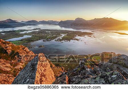 Stock Photography - View from the top of Hoven at sunset, behind the sea and fjord, Gimsøy, Lofoten, Nordland, Norway, Europe. Fotosearch