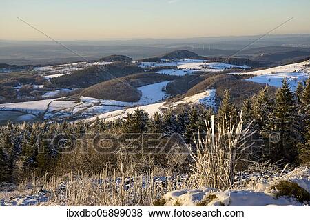 Stock Photo - View from the Wasserkuppe over the chain of hills of the Rhön in winter, nature park Park Hessian Rhön, Hesse, Germany, Europe. Fotosearch